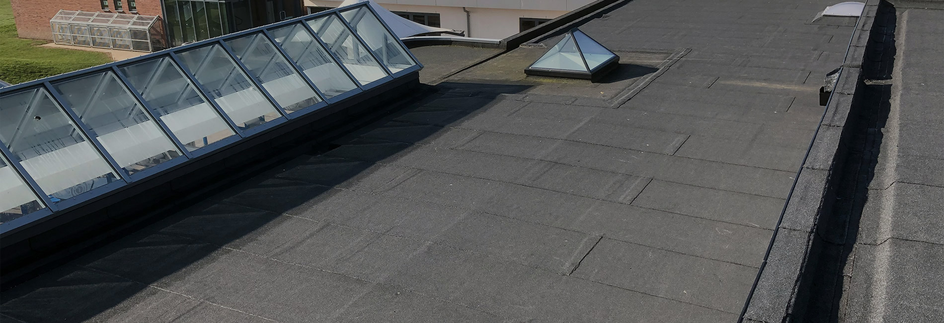 Flat roofing work in progress on a commercial building